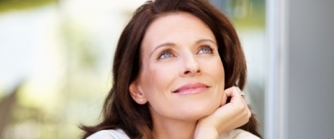 Lovely mature woman looking away in thought